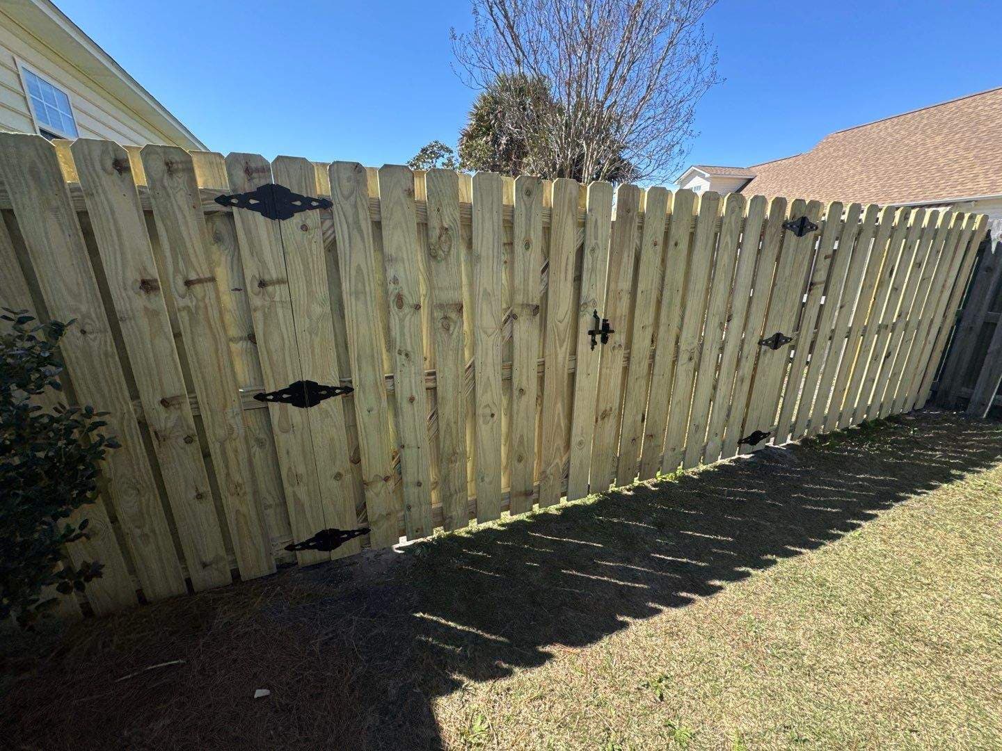 New wood fence and gate after a full replacement in the Wilmington, NC area