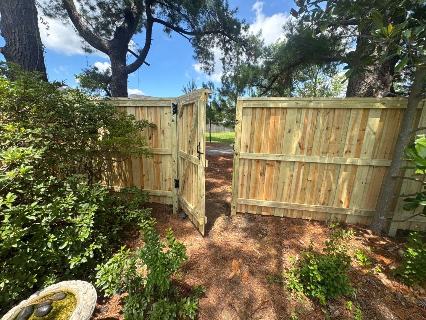 Custom wood double drive gate and privacy fence installation in the Wilmington, NC area